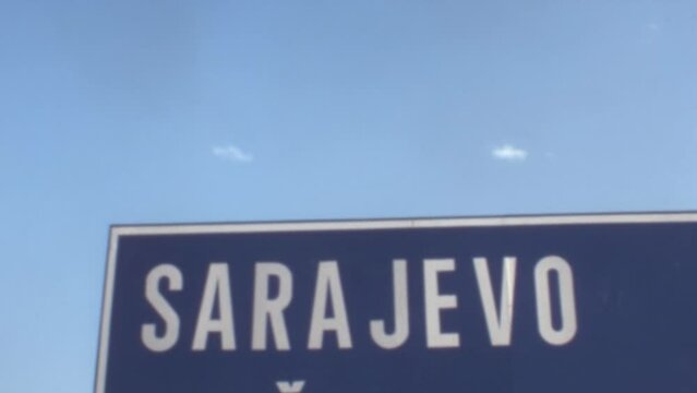 Sarajevo Road Sign in White on Blue Background. Copy Space. 1970s Original Historical Footage of Bosnia Erzegovina ex Yugoslavia