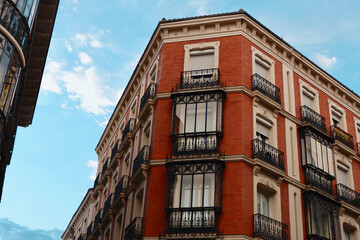 Fototapeta premium Classy vintage buildings with elegant black metallic balconies in the center of Madrid, Chueca district, Spain