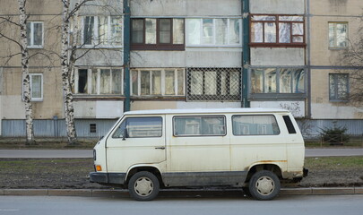 An old rusty white minibus parked on the road, Iskrovsky Prospekt, St. Petersburg, Russia, April 2023