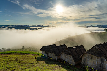 Straw huts lined up at the top of the mountain Looking out over the mountains and the beautiful misty sea