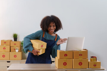 American African entrepreneur smile and checking online order. Successful SME entrepreneur concept