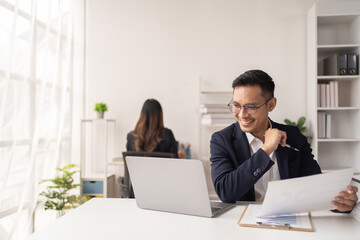 Business man working at the office and smiling .
