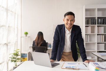 Business man working at the office and smiling .