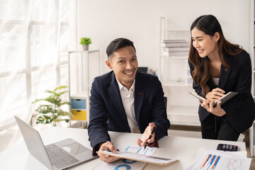 The couple of business talking about the project  and make deal in the office.