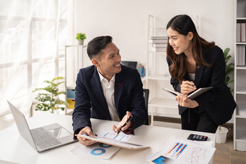 The couple of business talking about the project  and make deal in the office.