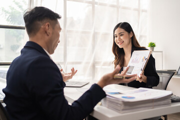 The couple of business talking about the project  and make deal in the office.