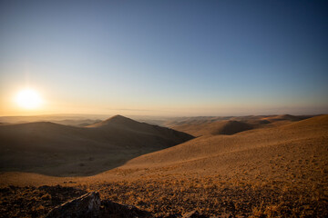 Fototapeta na wymiar Sand dunes of the desert against the backdrop of sunrise