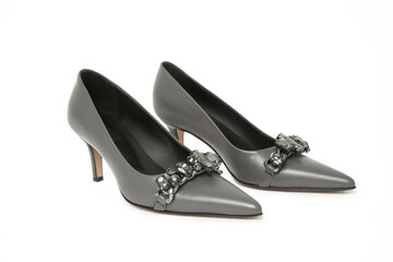 Grey leather pumps with rhinestones isolated on white. Classic middle heels with sharply pointed toes.