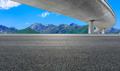 Asphalt road and bridge with mountain background