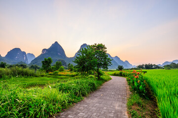 The walkway leads to the mountains in the distance. Landscape of Guilin, Guangxi, China.