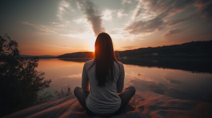 Young woman practicing yoga in mountains at sunset. Harmony, meditation, healthy lifestyle, relaxation, yoga, self care, mindfulness concept