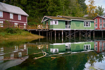 Fototapeta na wymiar Boardwalk Accommodations on Pilings Historic Telegraph Cove. The Telegraph Cove boardwalk and accommodations built on pilings reflecting in the water surrounding this historic location.