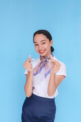 A flight attendant showing affection and love by doing the finger heart sign. Stewardess making a...