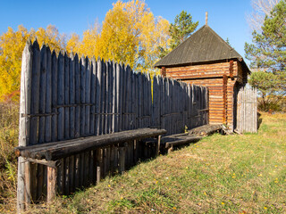 Reconstructed wooden watchtower of the 17th century and a palisade made of sharpened logs in the...