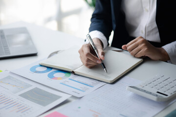 Businessman working in a private office, she is reviewing the company's financial documents sent from the finance department before he takes it to a meeting with a business partner. Financial concept.