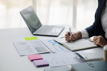 Businessman working in a private office, she is reviewing the company's financial documents sent from the finance department before he takes it to a meeting with a business partner. Financial concept.