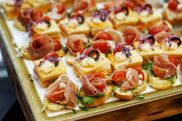 Top view of small sandwiches with prosciutto set.