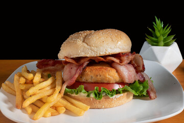 blt salmon burger with a side of fries