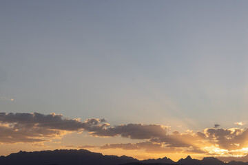 Wolken, Berge und Sonnenstrahlen am Himmel. Urlaub und Sonnenuntergang in Ägypten, Hurghada, Makadi Bay