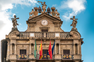Fototapeta premium PAMPLONA , NAVARA - SPAIN .View of Consistorial Square and Town Hall building. Spanish and Navarra Flag. Beautiful architecture. 