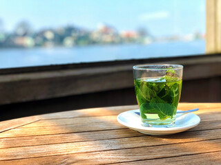 A mug of mint tea, a relaxing drink, a tea party, a cafe with a terrace.