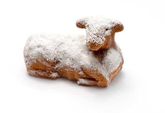 Isolated Easter Sweet Lamb Pound Cake Sprinkled With Powdered Sugar On White Background. Traditional Easter Food, Dessert Concept. Horizontal Plane