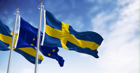 The flags of Sweden and the European Union waving together on a clear day - obrazy, fototapety, plakaty