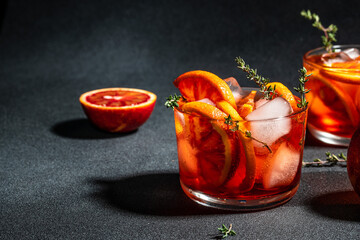Aperitif alcohol cocktail ice and Sicilian red oranges. Summer refreshing cocktail, place for text,...