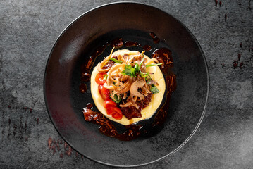 Stewed veal cheeks with mashed potatoes on plate