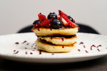 Close Up of American pancake with strawberries, Blueberries and Syrup
