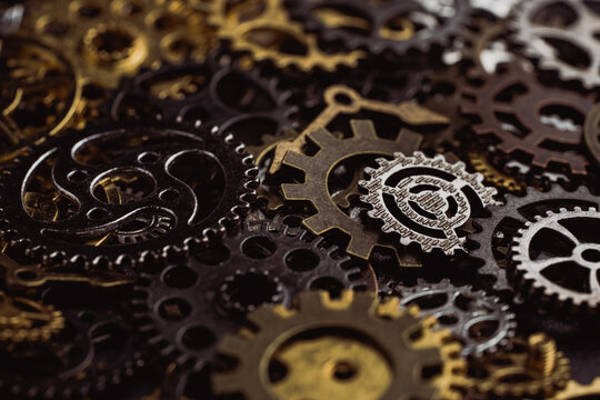 Shiny gears of cold steel colors on dark background