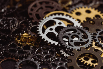 Shiny gears of cold steel colors on dark background