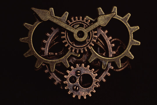 Shiny gears of cold steel colors on dark background