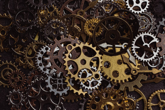 Shiny gears of cold steel colors on dark background