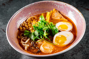 Asian noodle soup, ramen with chicken, tofu, vegetables and egg in bowl