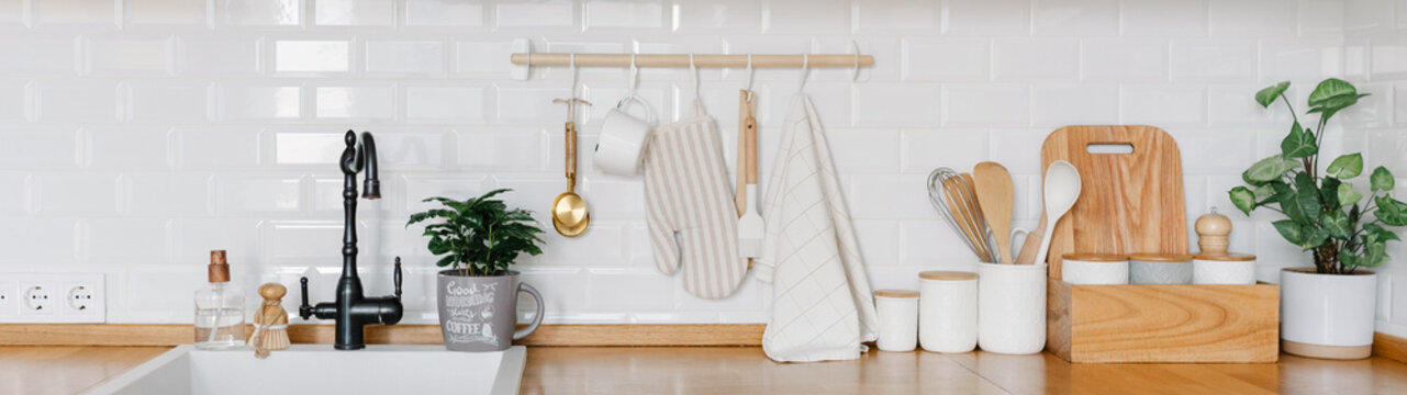 View of white modern country style kitchen interior with hanging storage, eco friendly food storage.