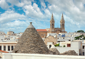 Trulli houses in main touristic district of Alberobello beautiful old historic town, Apulia region,...