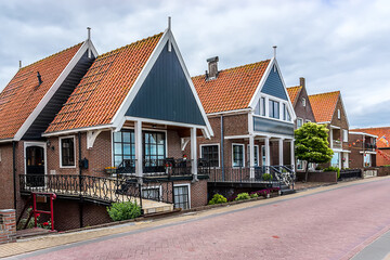 Fototapeta na wymiar Beautiful traditional houses in a Dutch small fishing village. VOLENDAM, the NETHERLANDS.
