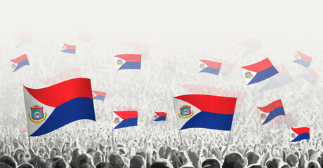 Abstract crowd with flag of Sint Maarten. Peoples protest, revolution, strike and demonstration with flag of Sint Maarten.