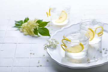 Elderflower lemonade or gin sour with lemon and freshly picked elderberry flowers. Healthy...
