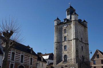 Exterior view of the old bell tower and historic buildings of Saint Riquier in the Somme department, Hauts-de-France, in France. The medieval tower is UNESCO World Heritage listed.