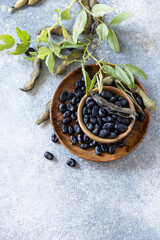 Organic food.  The concept of vegan or diet food. Fresh ripe black soy beans on a stone background. View from above. Copy space.