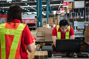 Warehouse worker checking details stock product and scanning a barcode on box package in the background warehouse., Industrial and industrial concept.