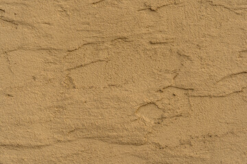 Fototapeta na wymiar Old traditional house wall texture. Brown beige sandy color rough plaster background.