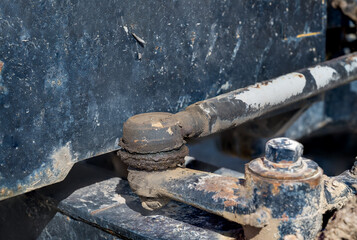 Detail of old tractor and steering parts front axle with grease zerk