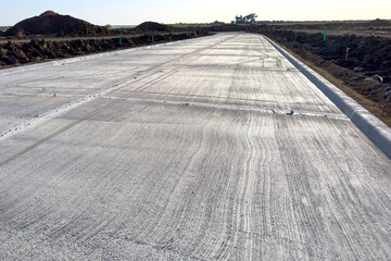 Construction of a new concrete road, concrete ground for a new roadway.