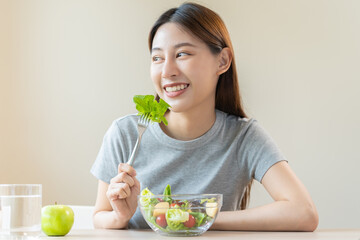 Diet, Dieting asian young woman or girl use fork at lettuce on mix vegetables, green salad bowl,...