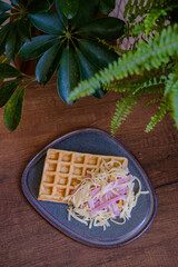 Hearty waffle with cheese and ham
