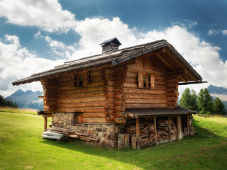 Landscape photo of a little wooden chalet in the alps