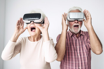 Old couple of husband and wife, enjoying retirement - they are having fun with VR headsets. Generative AI